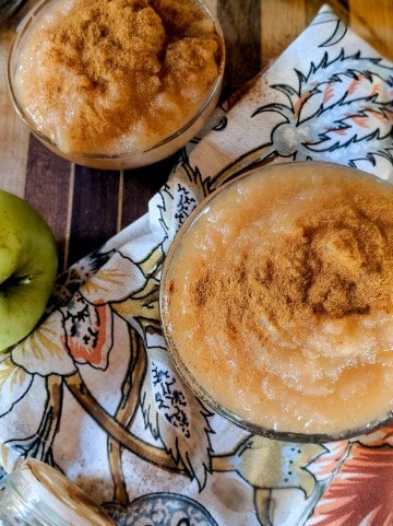 overhead image of an applesauce bowl on top of a dish towel