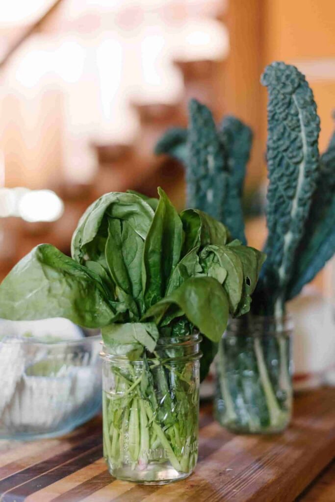 kale and spinach in a mason jar of water. 